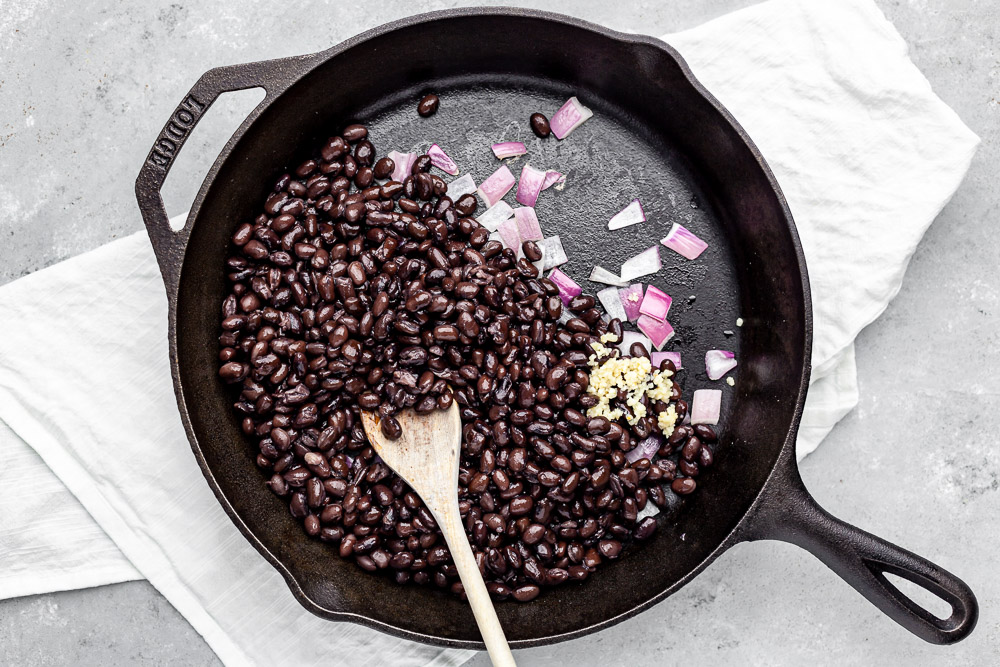 bean recipe vegan - stirring ingredients in pan