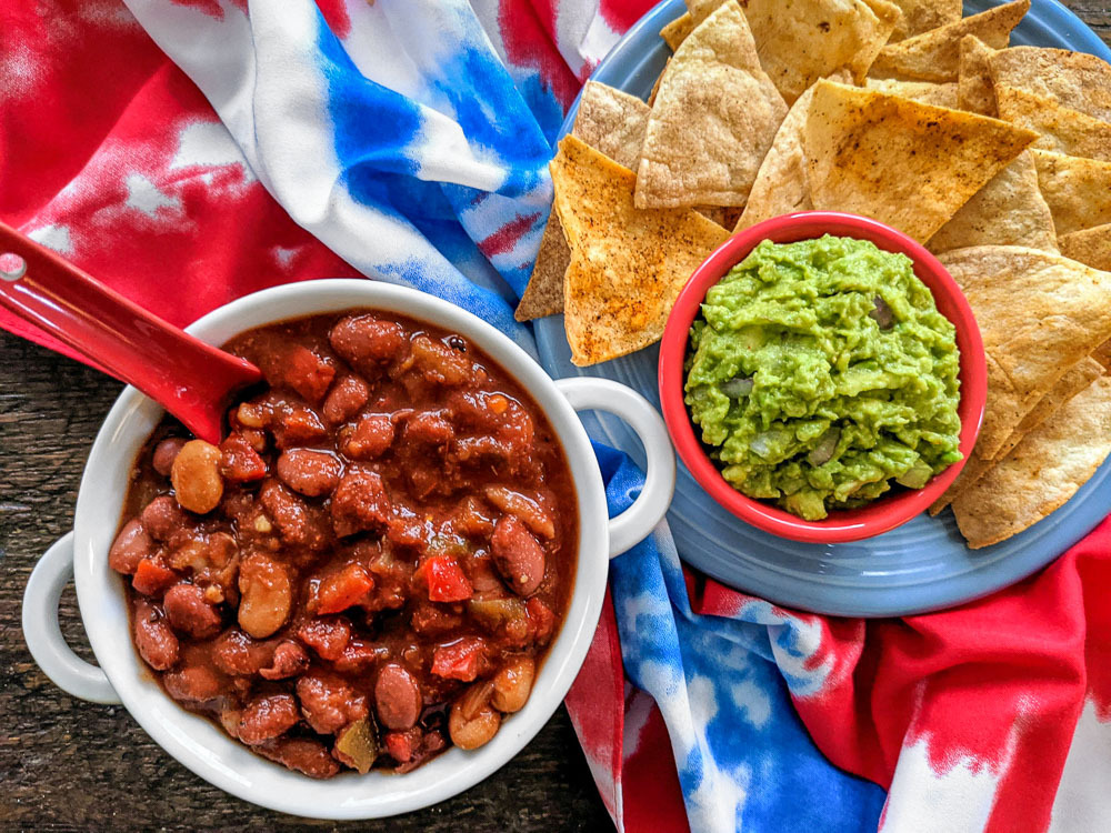 whole food plant based chili with baked tortilla chips and guacamole