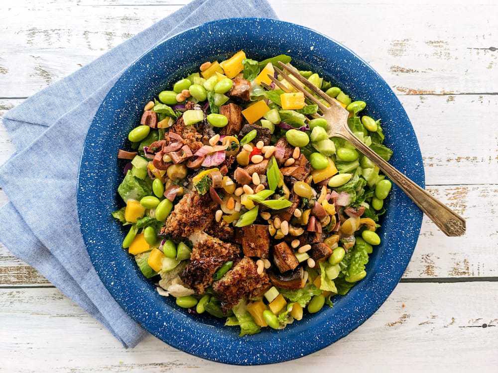 Plant Based Mighty Muffuletta Salad with Blackened Portobellos and Sunny Artichoke Dressing