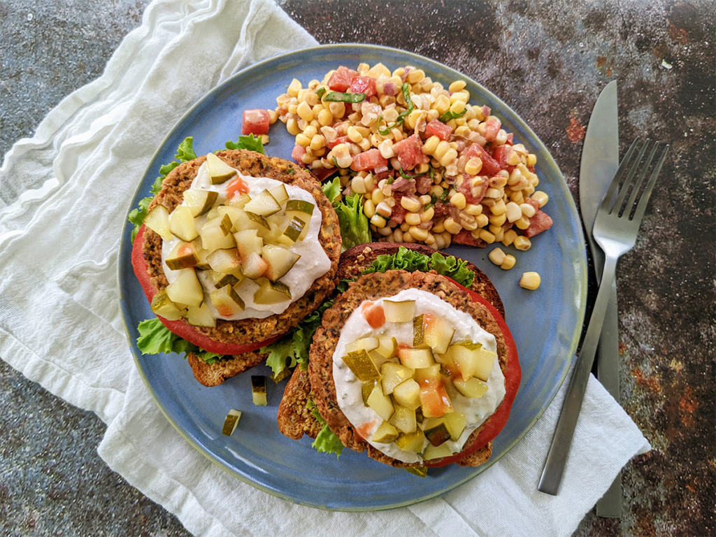 Open face Surfs Up Sandwich with Lemony Herb Dairy Free Sour Cream and Sweet Corn Tomato Salad