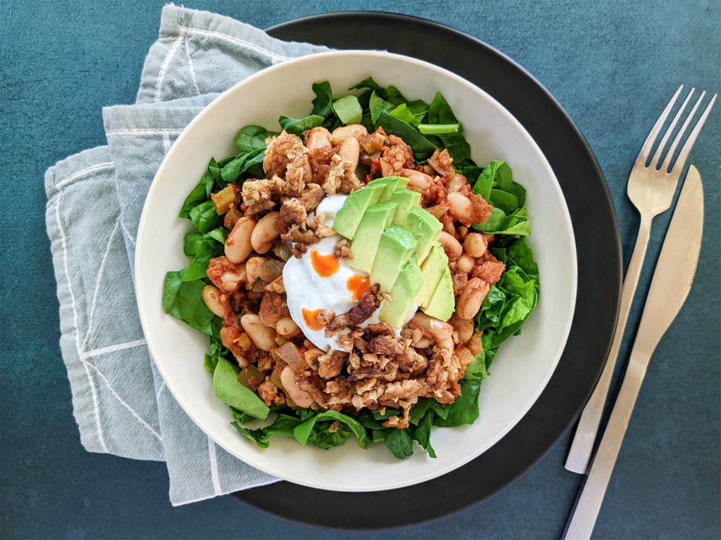 Smoky Bavarian-inspired Beans over Chopped Spinach with Dairy Free Sour Cream