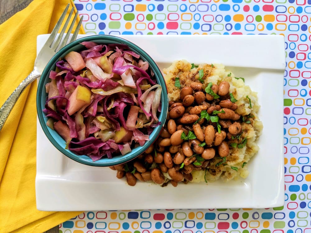 sweet and sour cabbage and buttery mashed potatoes with kielbasa-spiced pintos