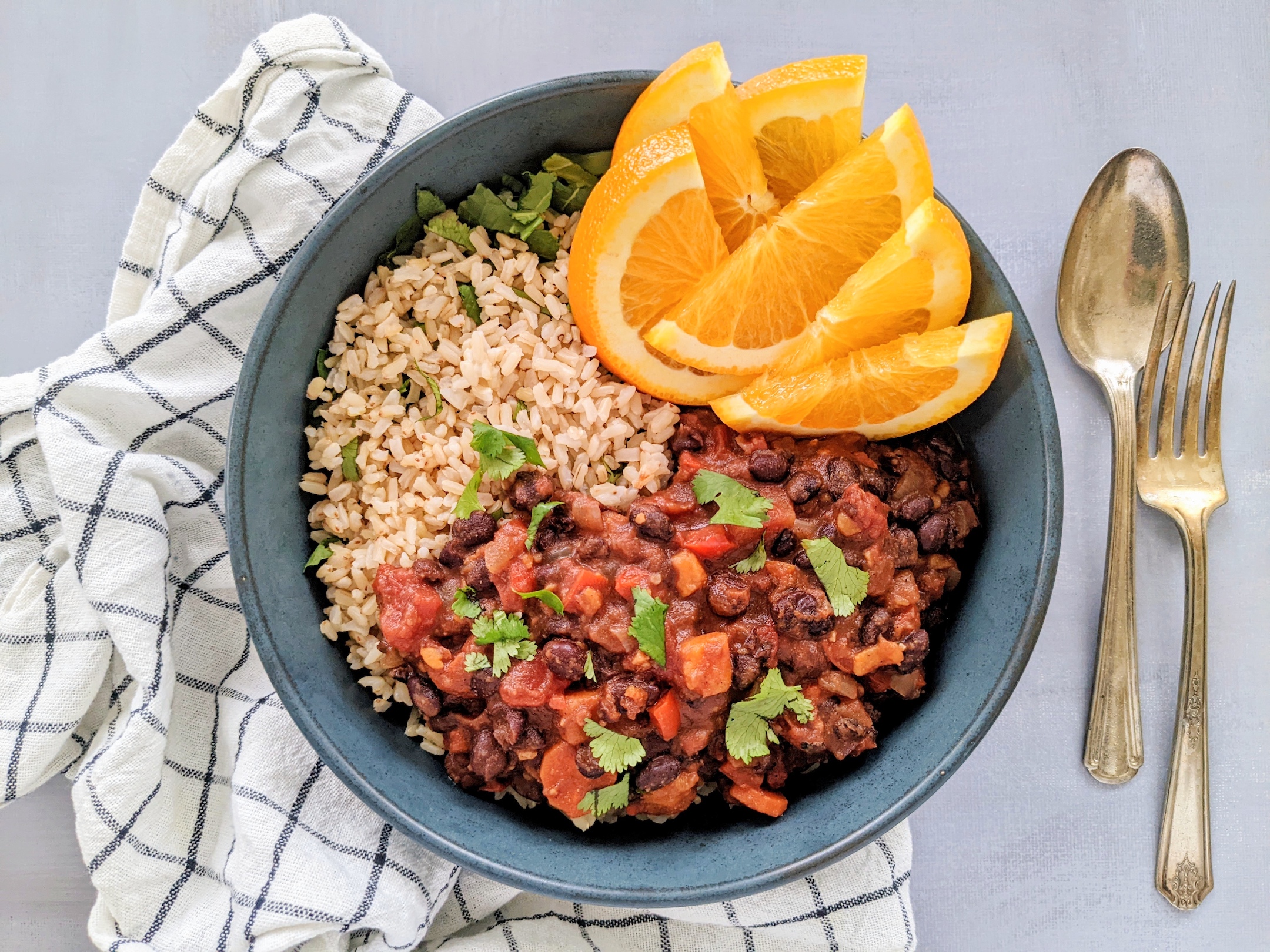 Brazilian-style Black Bean Stew (Feijoada) with Rice and Orange Slices 