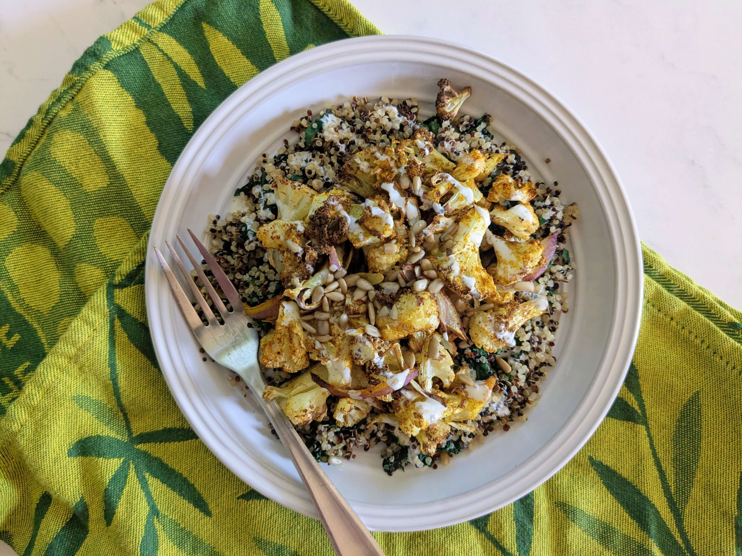 Curry Roasted Cauliflower over Quinoa with Cilantro Cream Sauce