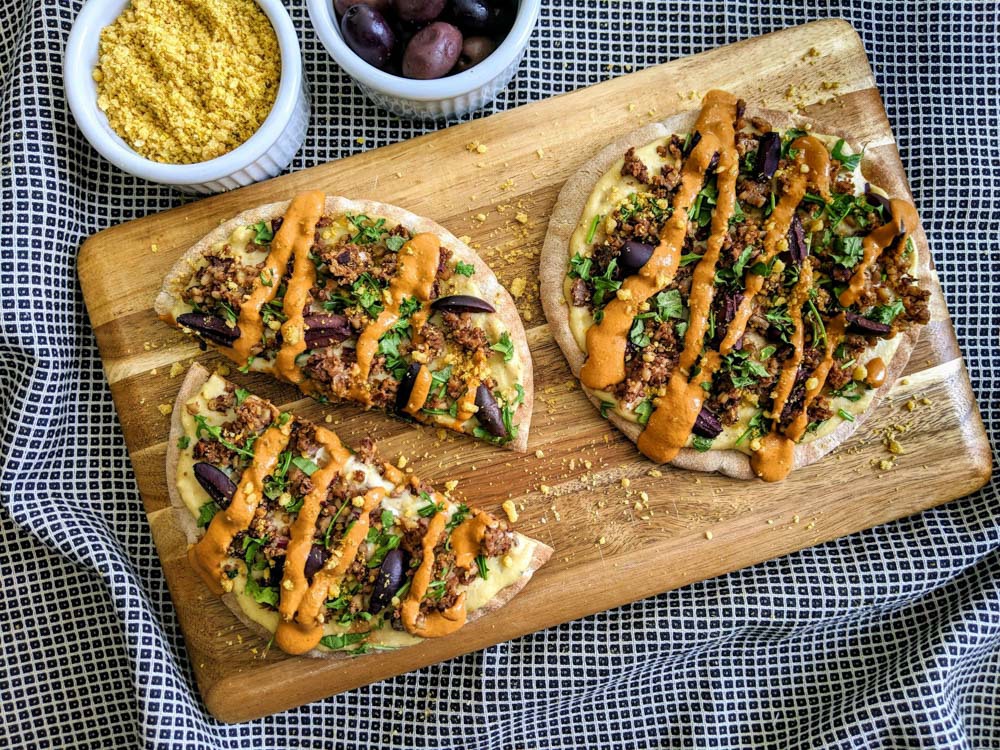 The Loaded Crispy Flatbread with Arugula & Kalamata Olives 